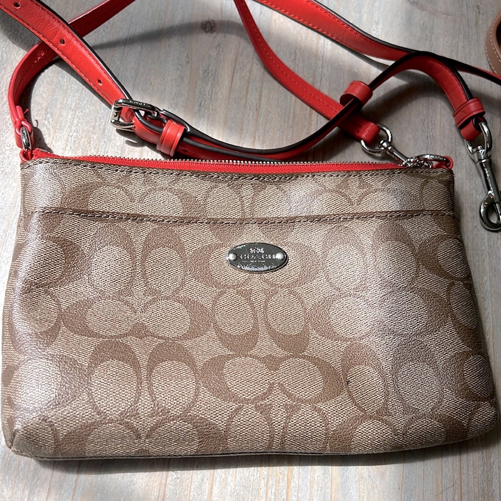 Coach Clutch with Orange accents, inside and two different sized straps